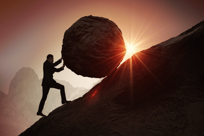 Man pushing rock uphill