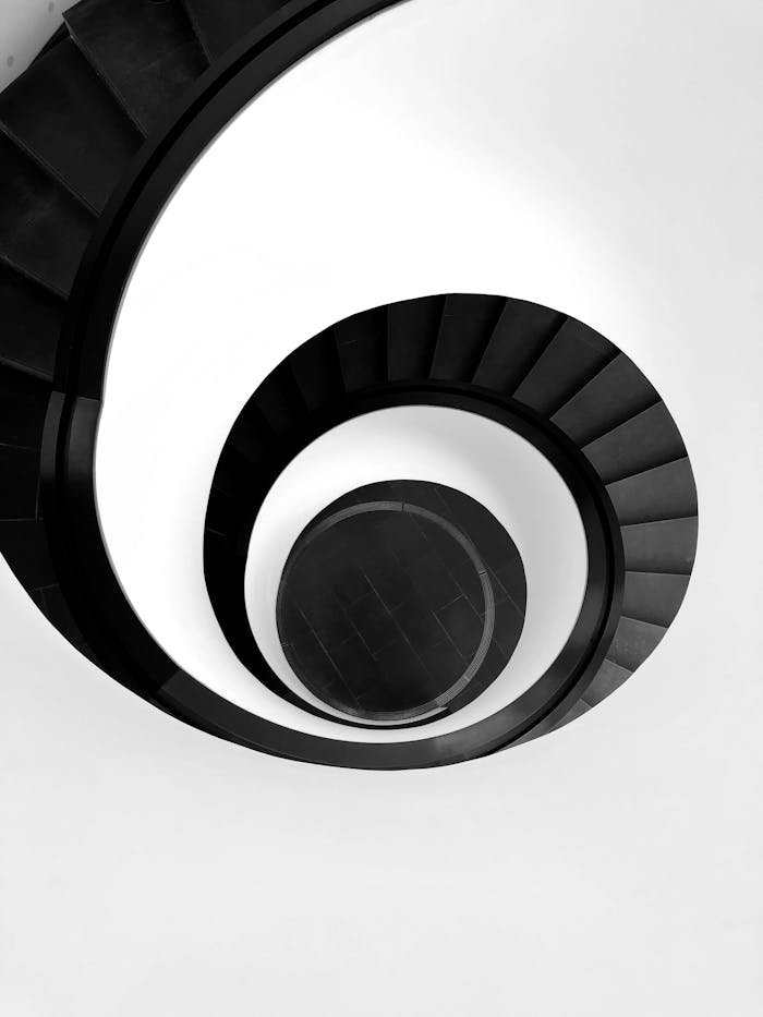 Black and white abstract of a spiral staircase in Nürnberg, Germany showcasing minimalism and modern architecture.